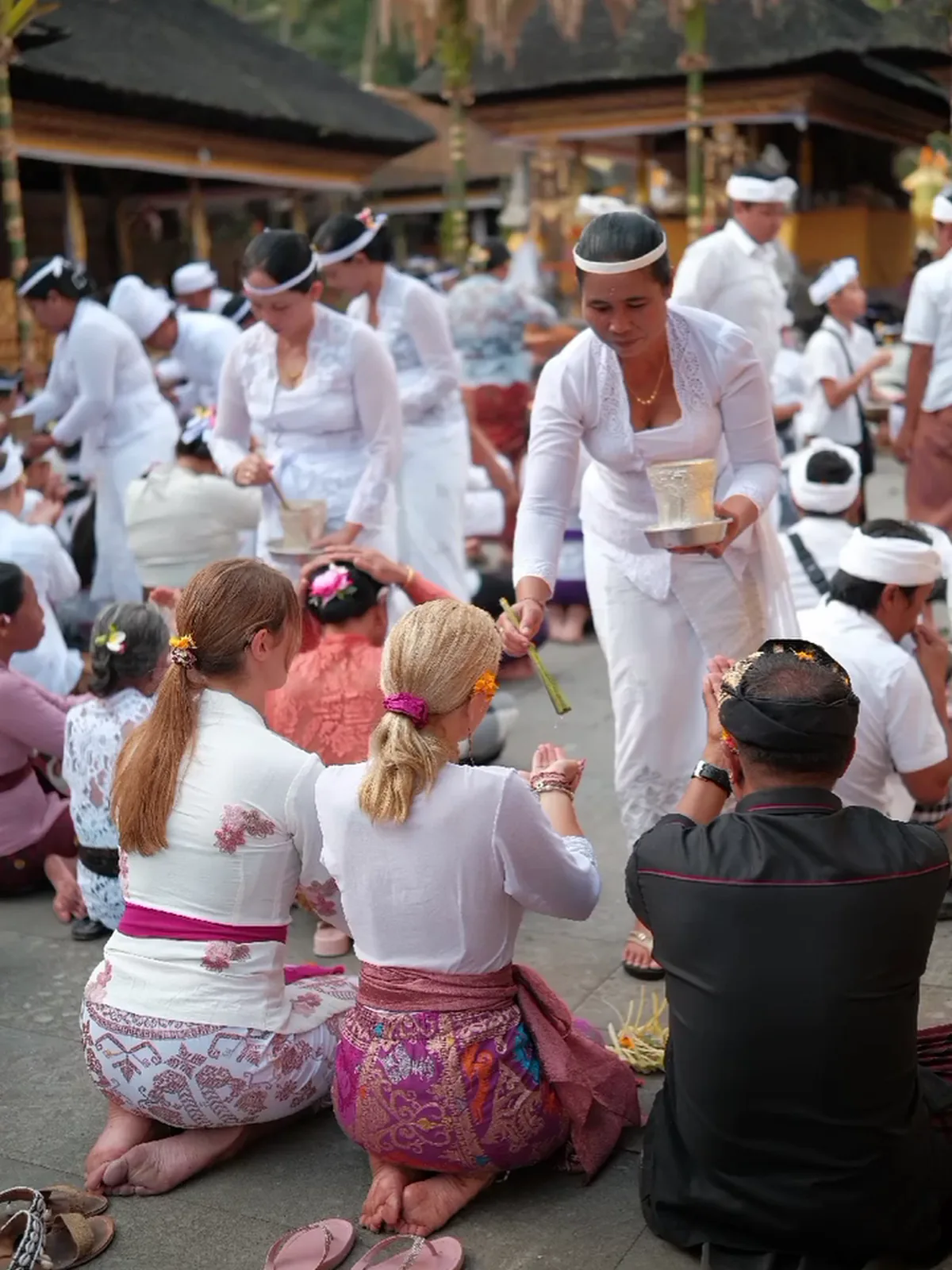 A Balinese ceremony, worshippers dressed in white